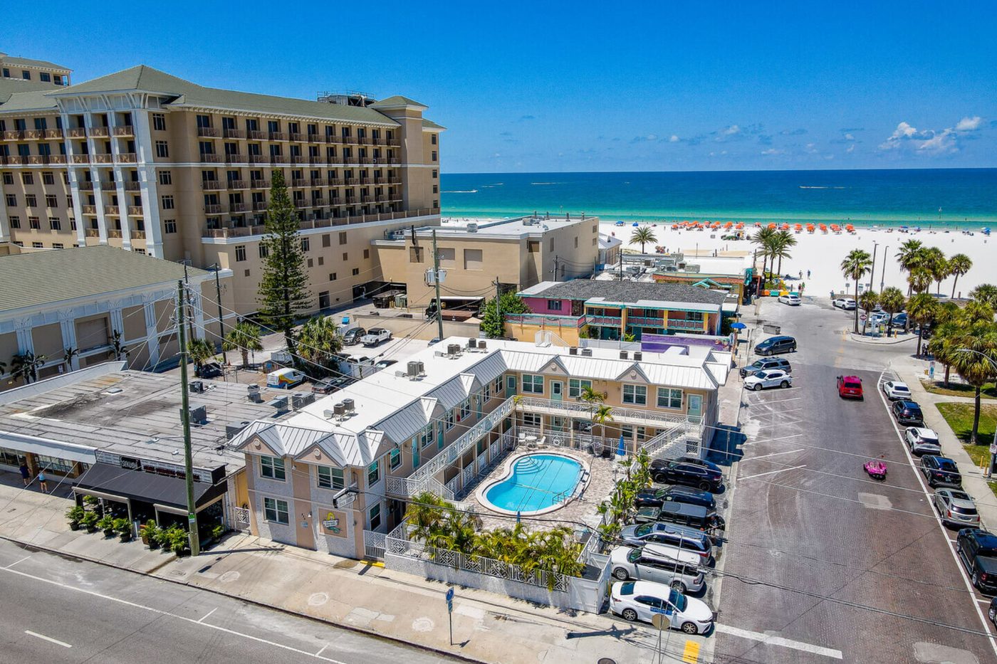 Clearwater Beach Suites exterior, aerial view with pool, steps from the beach